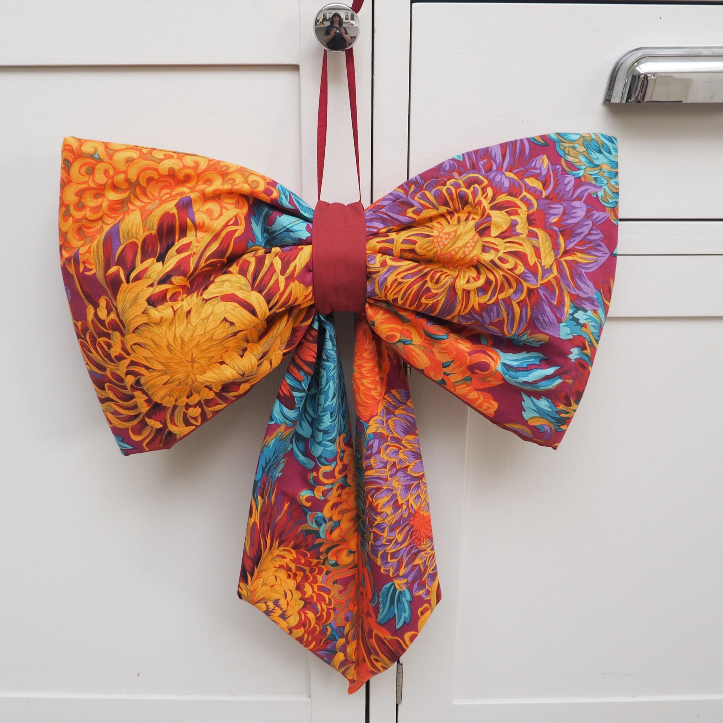 Handmade large padded decorative hanging bow - orange/purple floral